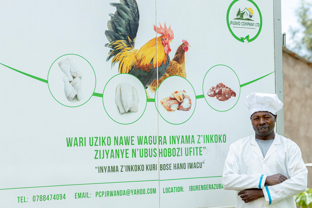 A man standing in front of a sign.