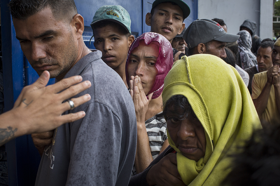 This photo is part of CRS' best photos of 2018, it's Venezuelan refugees in Colombia receiving aid.