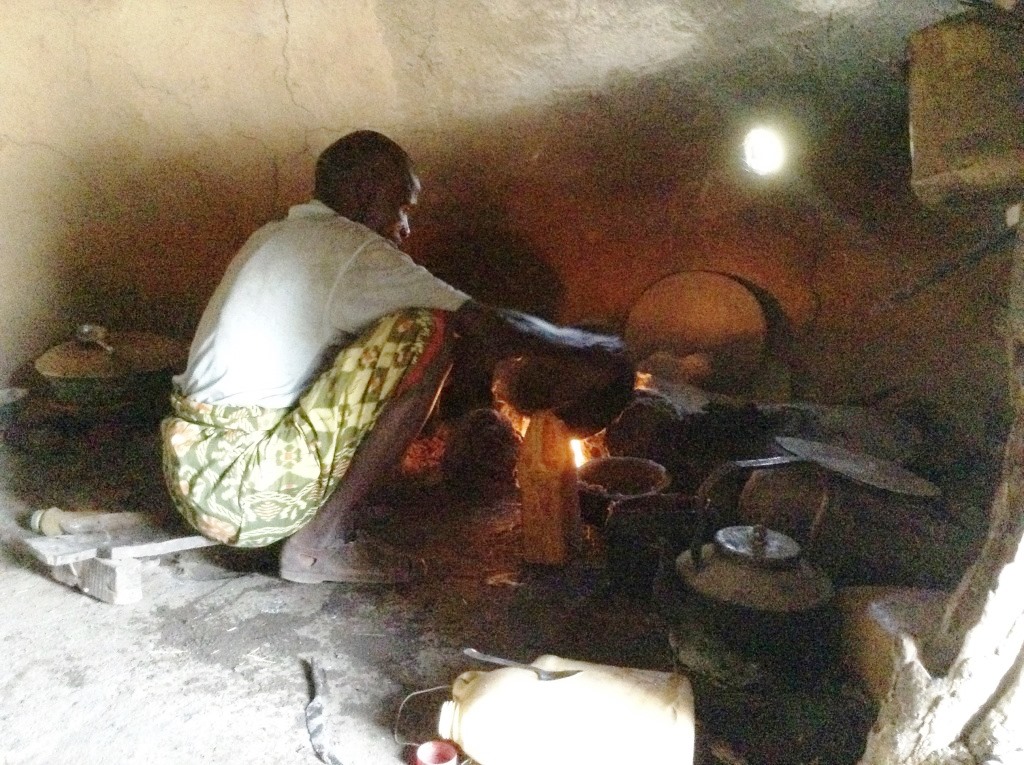 Ahmed prepares food for his children. Photo by Seble Daniel for CRS