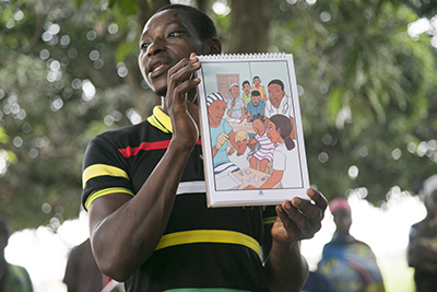 Simon Aiyana, a community health worker in Benin, educates communities about the risks of malaria and encourages people to protect themselves against mosquito bites. Photo by Michael Stulman/CRS