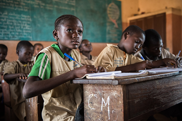 Student in classroom in Benin CRS school meal program