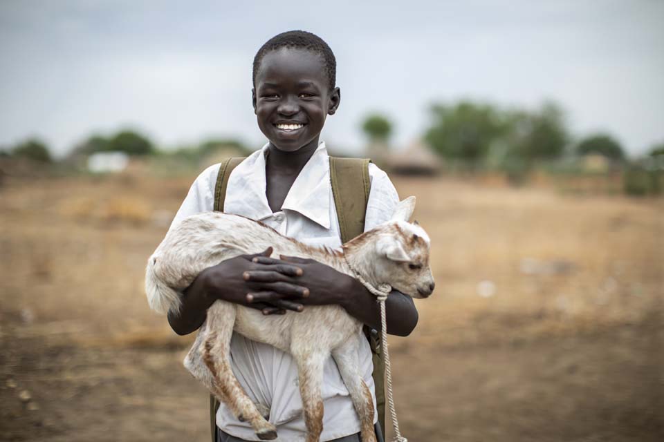 boy holds goat in South Sudan