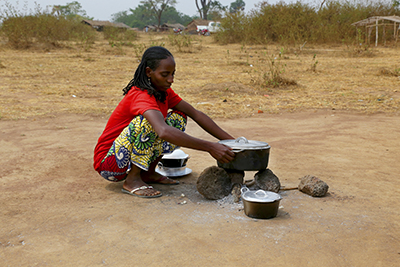 Djouleyatou Ousman cooks with kitchen supplies distributed by CRS in Eastern Cameroon. Photo by Michael Stulman/CRS