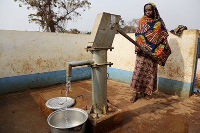 Every morning, Adidja Anina collects water for drinking and household use from a community pump in Eastern Cameroon. Photo by Michael Stulman/CRS