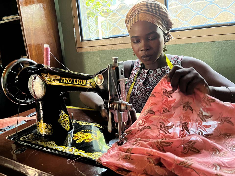 Cameroon woman at sewing machine