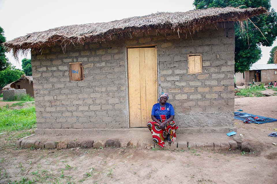 woman_sits_outsider_her_home_in_central_african_republic