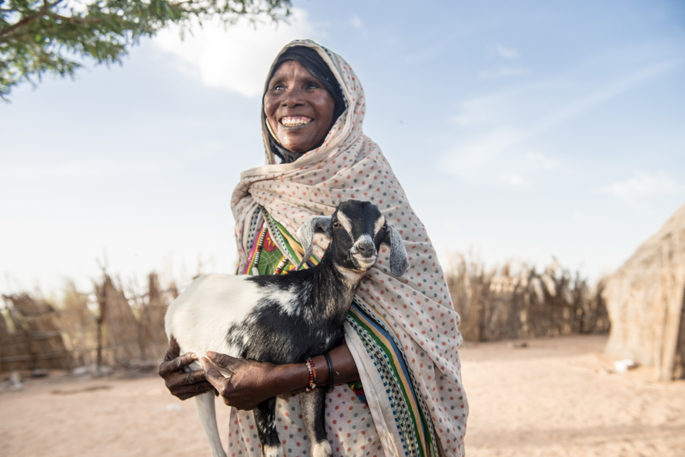 woman holding young goat