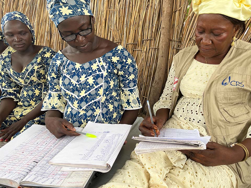 women examine register in Chad