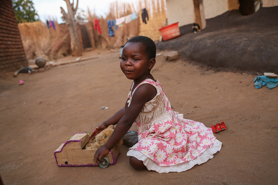 child playing with homemade toy in Malawi