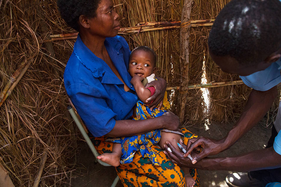 child receives vaccination in Malawi