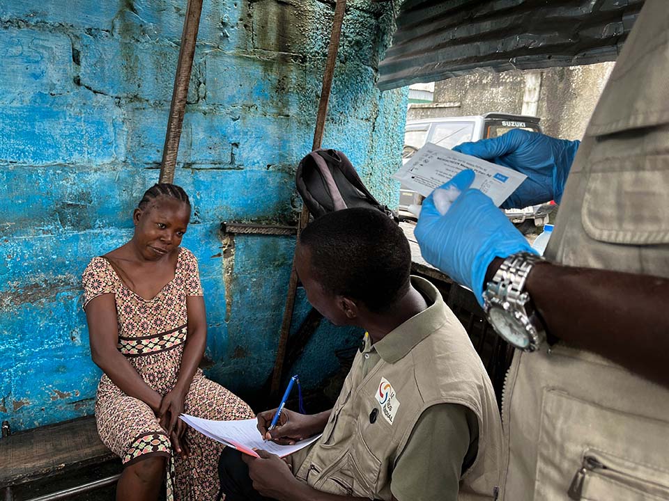 health care worker consults with woman in Republic of Congo