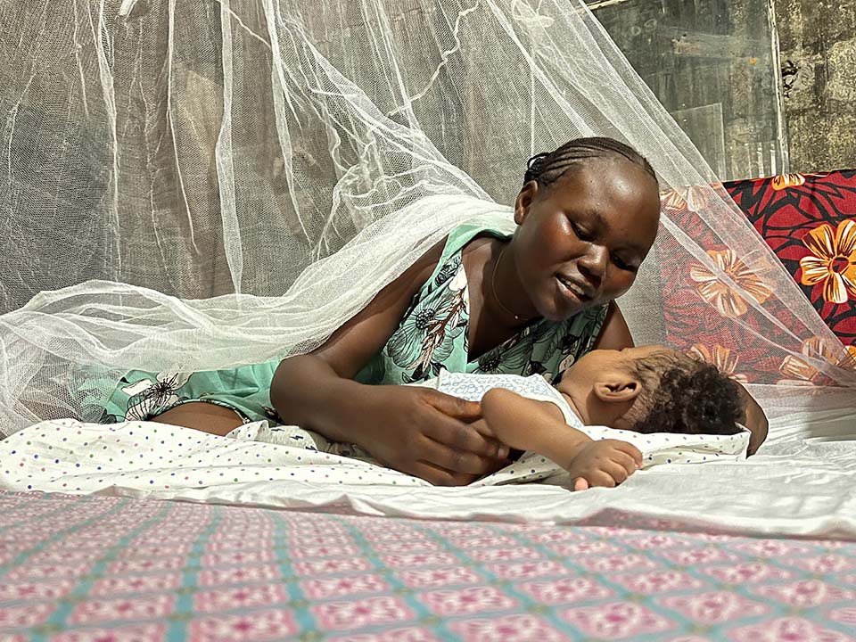 mother and child under bed net in Republic of Congo