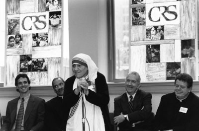 Mother Teresa speaks during her 1996 visit to CRS headquarters with, from left to right, Sean Callahan, Bishop John Ricard, Ken Hackett and Father Brian McCullough looking on. Photo by CRS staff