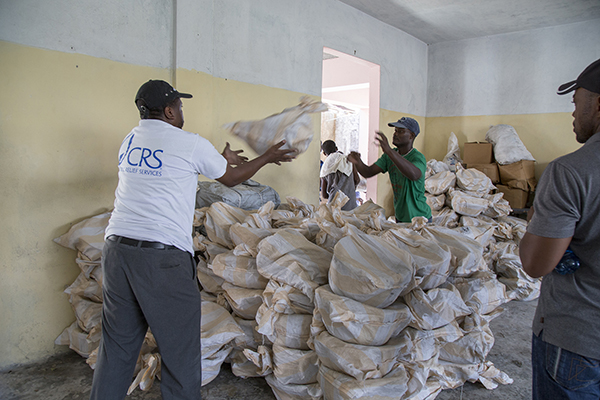 At the Catholic church in Port Salut, Haiti CRS employees load up a church dispensary with supplies for distribution to survivirs of Hurricane Matthew. Photo by Marie Arago for CRS