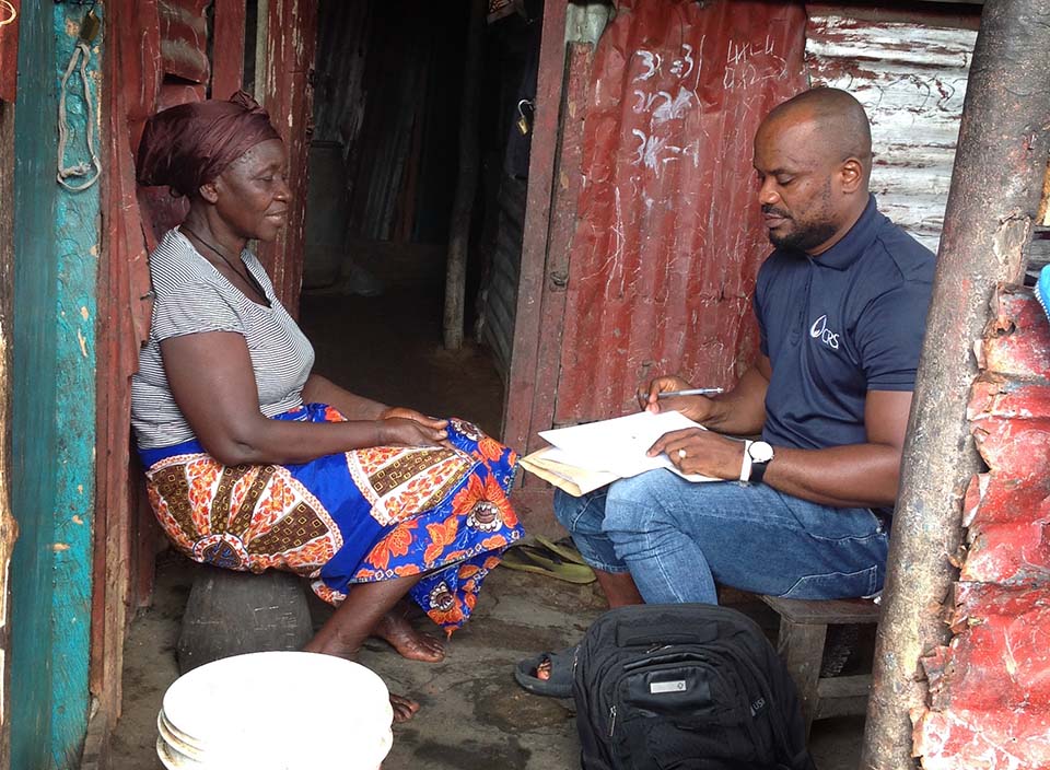 man and woman sit opposite each other in Liberia