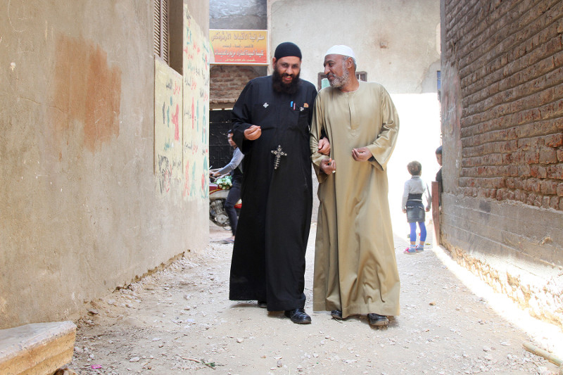 Through the CRS peacebuilding program TA'ALA, religious leaders Father Rueis, left, and Sheikh Moustafa work together to engage the faithful in interreligious dialogue in the village of Al Odayssat in Upper Egypt. Photo by Nikki Gamer/CRS