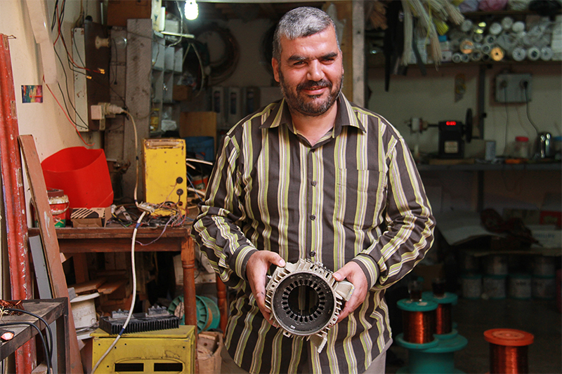 Photo by Nikki Gamer/CRS Mohammed is working on an engine in the Cairo repair shop he opened. “I want to thank CRS for giving me a new beginning,” he says.