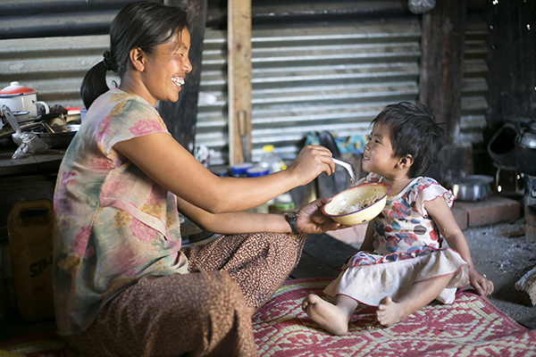 mother feeds child in myanmar