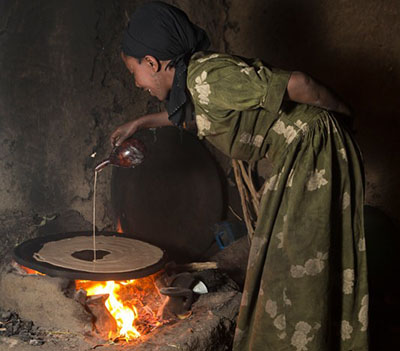 Abaynesh Legesse prepares traditional injera for sale in her kitchen in Benben Village, Ethiopia. She has seen her restaurant business increase five-fold since taking out a $50 loan for ingredients. Photo by Sara A. Fajardo