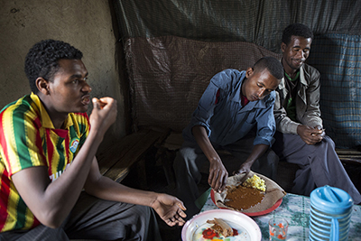 Photo by Sara A. Fajardo Customers enjoy injera and sauces in Abaynesh's restaurant. Previously, she could never produce enough food to meet the demand because she didn't have enough money to purchase ingredients in bulk. Photo by Sara A. Fajardo