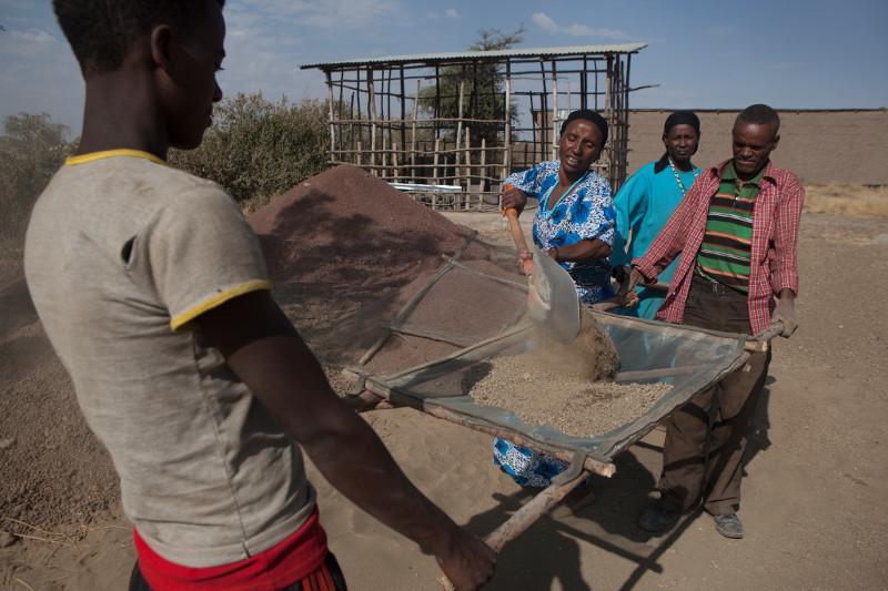Photo by Sara A. Fajardo/CRS Ayuba Ahmed shovels ash while other members of her stove-making group sift. The 12-member group manufactured and sold 458 stoves in its first year and increased their household incomes by an average of 6%. Photo by Sara A. Fajardo/CRS