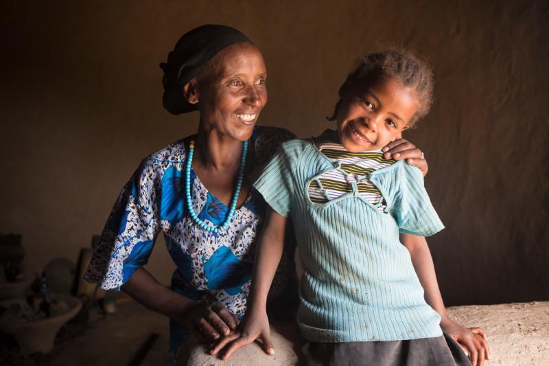 Photo by Sara A. Fajardo/CRS Ayuba in her kitchen with the youngest of her five children, Asia. Thanks to her new stove, Ayuba has more time to spend with her children. Photo by Sara A. Fajardo/CRS