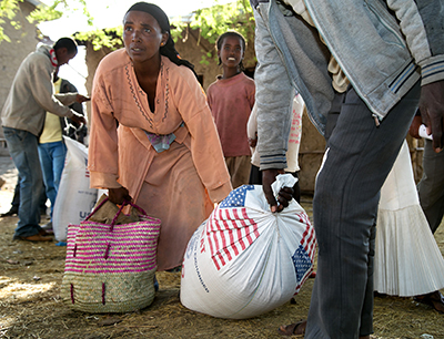 CRS is providing emergency food assistance to some of the most vulnerable Ethiopians. In Aje, families gather to take home rations of wheat and split yellow peas. Photo by Nancy McNally/CRS