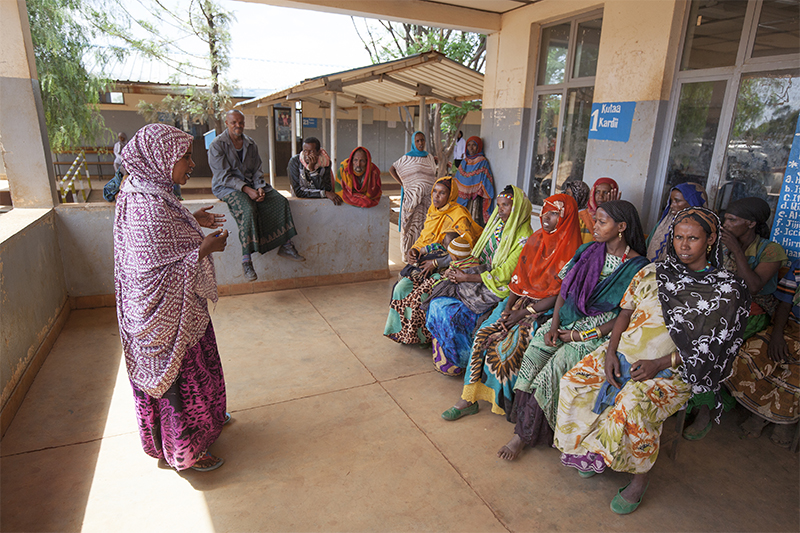 Photo by Petterik Wiggers for CRS Samia Abrahim, a CRS-trained health worker, teaches a group of new mothers about the importance of exclusive breastfeeding and child nutrition.
