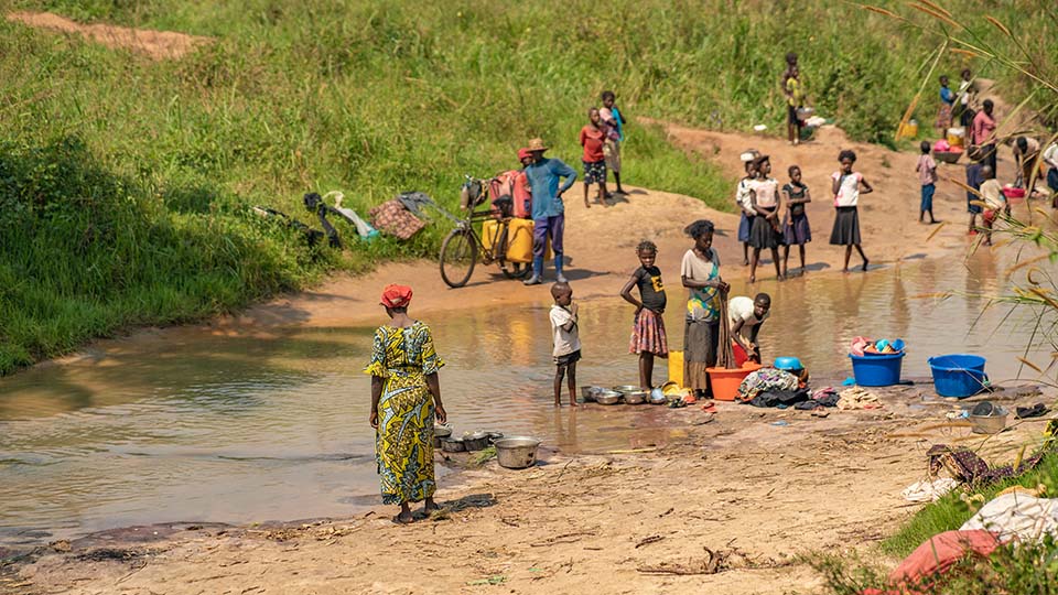 families gather at river in DRC