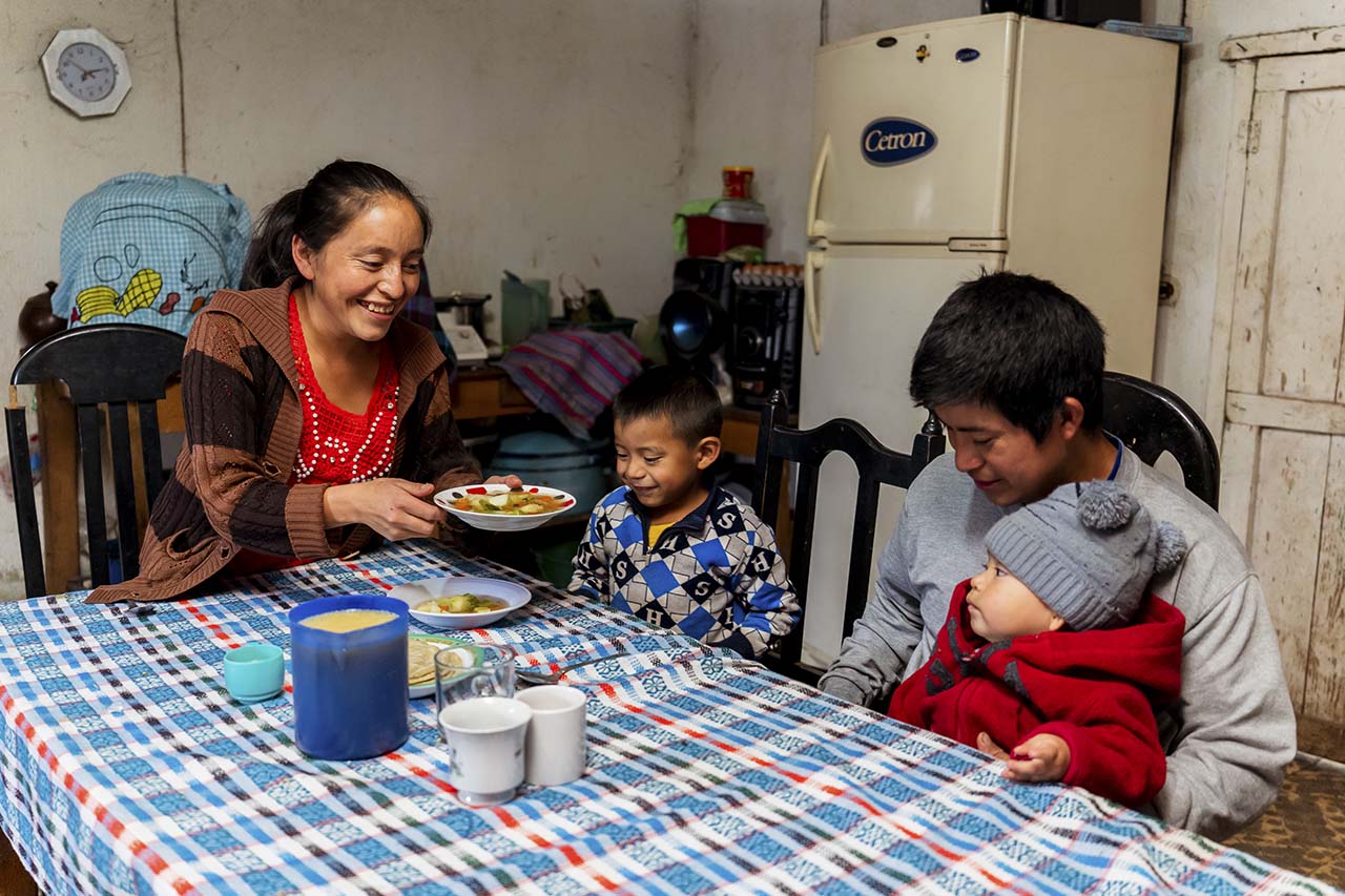 family around table at home in Guatemala