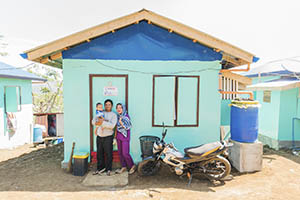 family stands outside shelter in Philippines