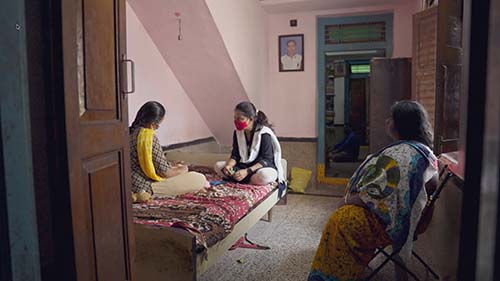 family sits together in India