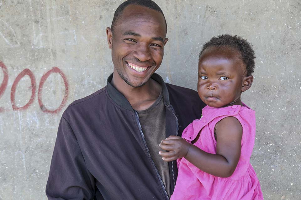 father and daughter facing camera in Rwanda