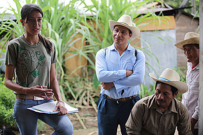 Photo by Silverlight for CRS Iris Santos, a technician for Guatemala's coffee association, talks with farmers about how to manage leaf rust. Photo by Silverlight for CRS