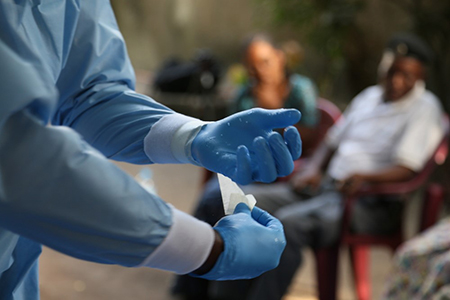 Health care workers in Guinea have historically been poorly equipped and are used to handling patients with minimal precautions. They need extensive and detailed training in infection control to keep Ebola from spreading. Photo by Michael Stulman/CRS