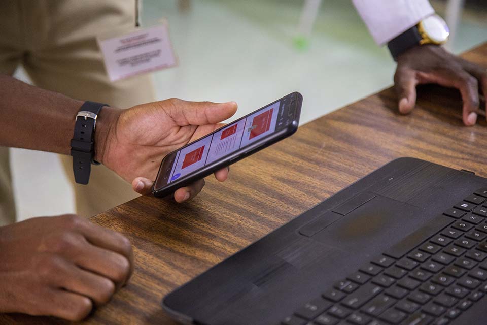 hand holding cell phone in Malawi