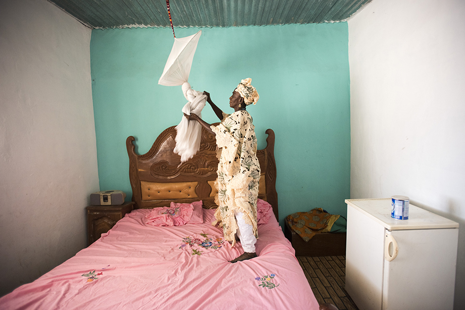 hanging a malaria net in the gambia