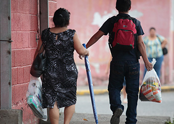 Migrants carry basic supplies offered by a care center in Honduras. Increasing desperation has led many people and children to flee their homelands. Photo by Oscar Leiva/Silverlight for CRS.