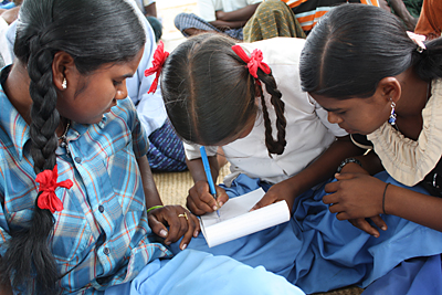 These 13-year-old girls were once dropouts. A CRS partner persuaded their parents to let them attend a bridge school to catch up on classes. They are now back in public school. Photo by Laura Sheahen/CRS