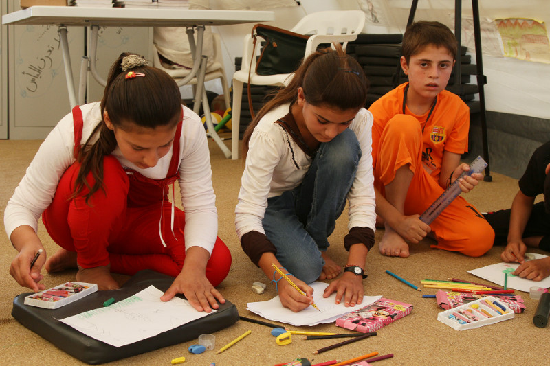 Children participate in activities like writing and drawing at CRS-run child support centers. Photo by Kim Pozniak/CRS