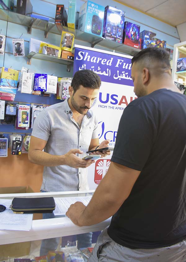 Iraq shop owner serves customer
