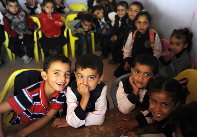 Children have a classroom again, thanks to community partnerships that are rebuilding neighborhoods and lives. Photo by Shareef Sarhan for CRS