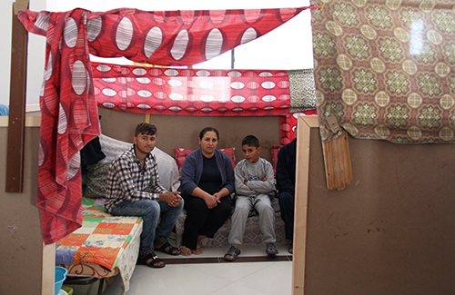 The Raeed family of five shares three mattresses in a tiny space at Our Lady of the Assumption Armenian Catholic Church in Amman, Jordan, after fleeing their home in Mosul, Iraq. Photo by Kim Pozniak/CRS