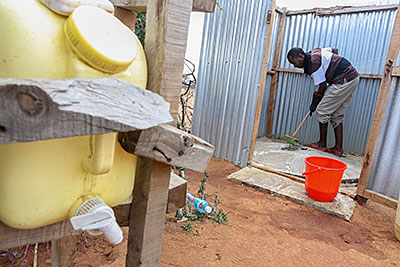 Photo by Sara A. Fajardo/CRS Ahmed Hussein disinfects the family latrine, a critical step that helps prevent disease. Photo by Sara A. Fajardo/CRS