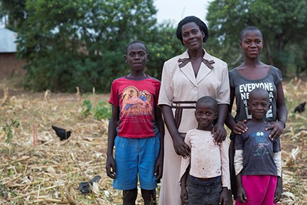 Janet Anyango Okeyo, with four of her six children, lost everything when her husband contracted HIV. The Children Behind, a CRS initiative, helped her earn enough to care for her family. Photo by Sara A. Fajardo/CRS