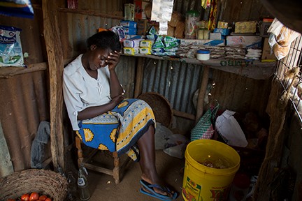A CRS-supported saving and lending group in Kenya is helping Janet Anyango Okeyo grow her store and care for her family. Photo by Sara A. Fajardo/CRS