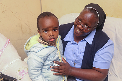 Sister Agnes Wamuyu, general secretary of the Association of Sisterhoods of Kenya, teaches the importance of nutrition, education and communication in early childhood development to families like Brian’s. Photo by Philip Laubner/CRS