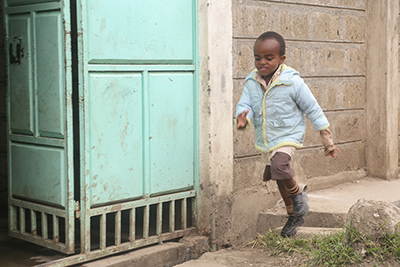 Brian Njoroge has a developmental delay, but has improved dramatically since his family enrolled in the SCORE-ECD project in Kenya. Photo by Philip Laubner/CRS