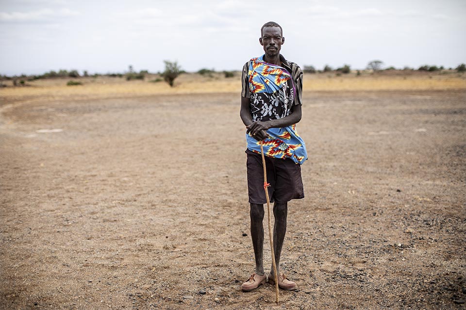 Kenya pastoralist stands in field