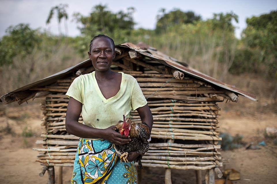 Kenyan woman holding a chicken